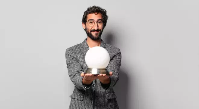 Business man holding crystal ball