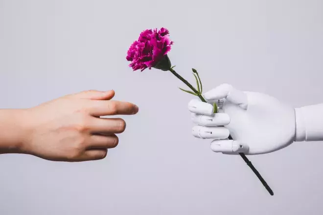 robot hand giving a flower to human hand