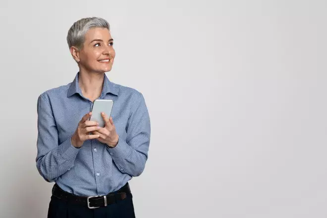 Business person smiling holding cell phone