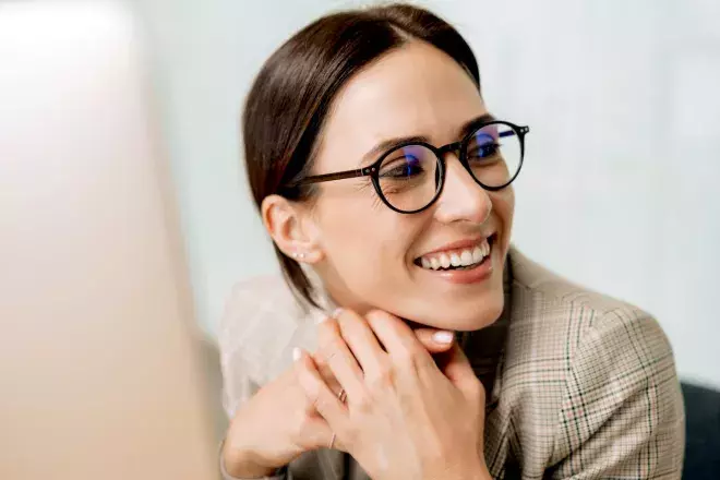 Woman at a computer smiling