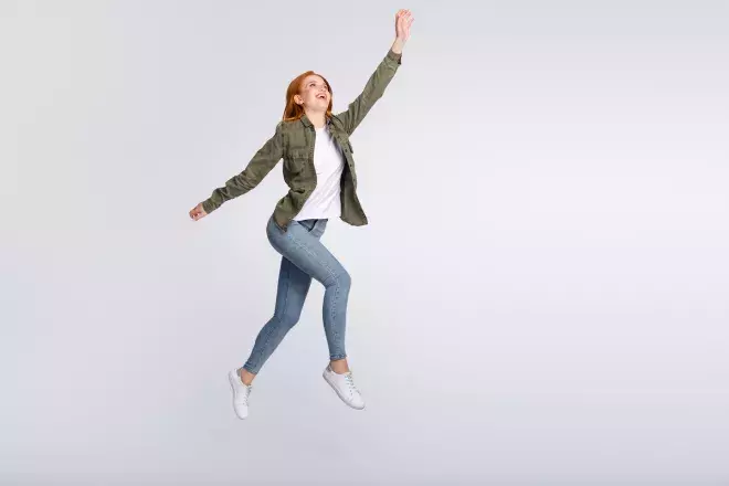 woman taking steps in mid air reaching up