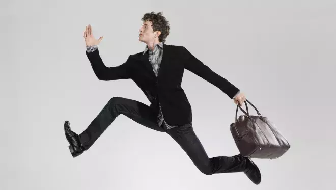 Business man leaping effortlessly 