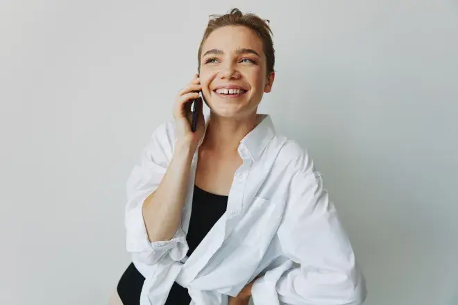 smiling person on cell phone