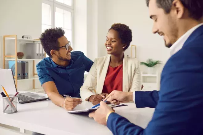 happy couple signing paperwork