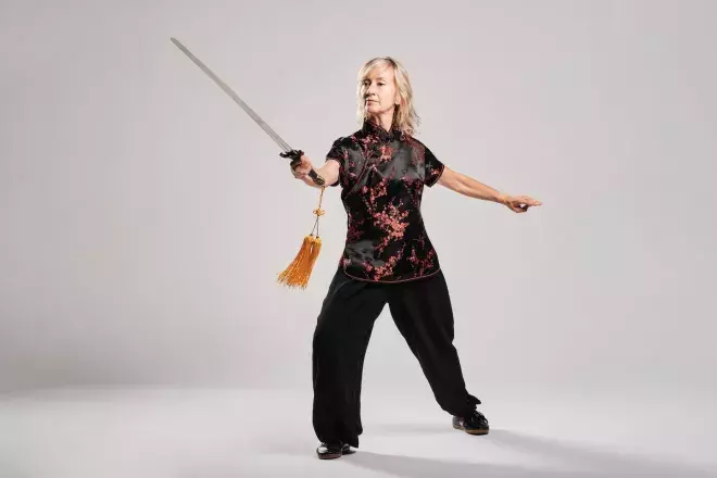 woman practicing Tai Chin with sword