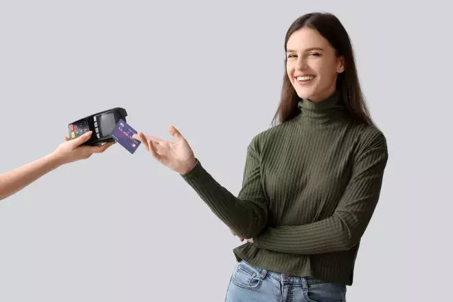 smiling woman swiping credit card