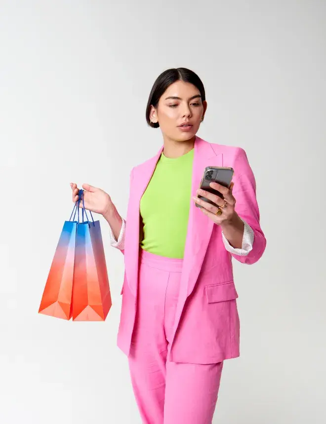 Woman with shopping bags looking at phone