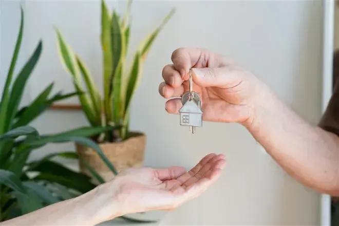 person handing over keys