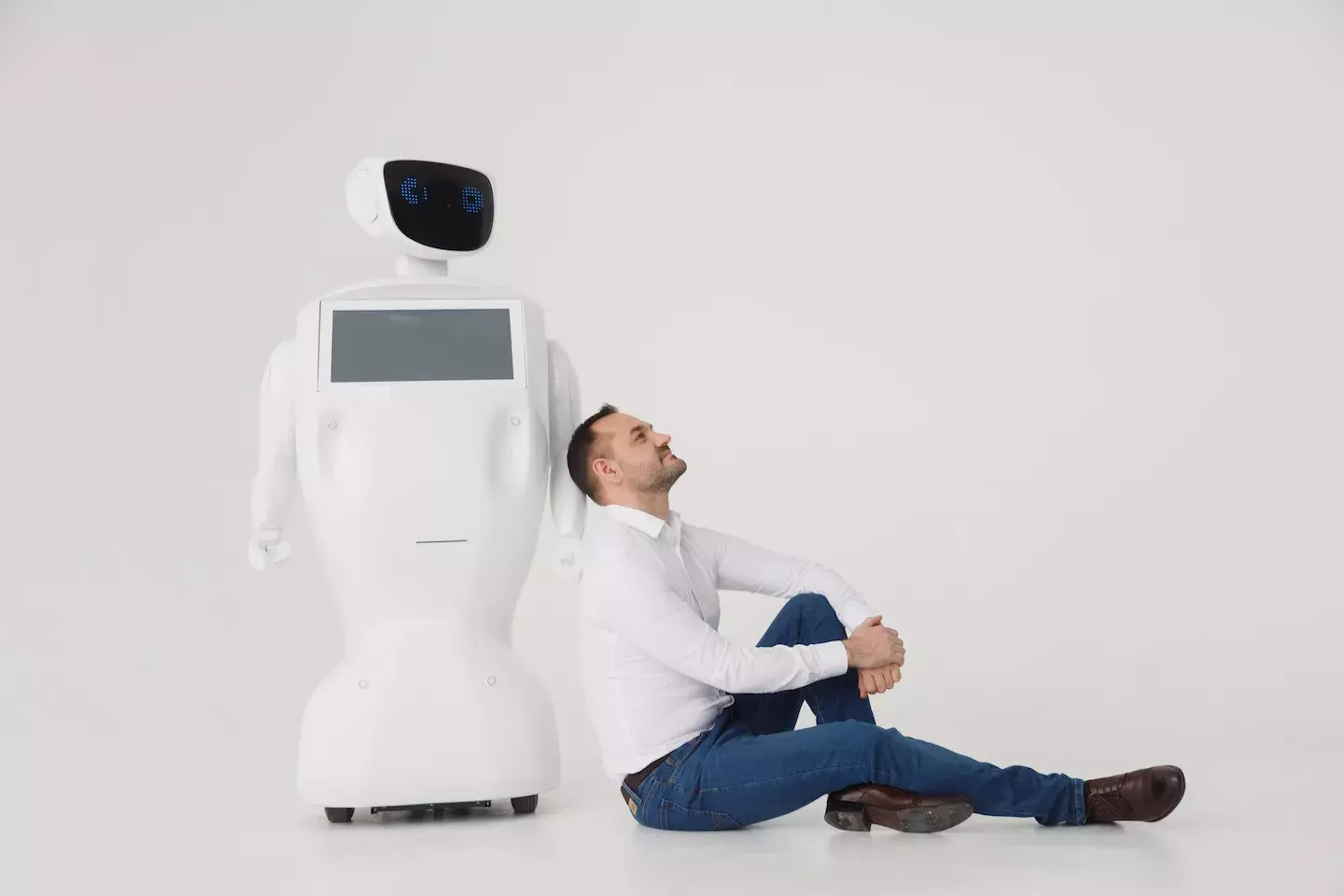 business man leaning against ai robot pondering