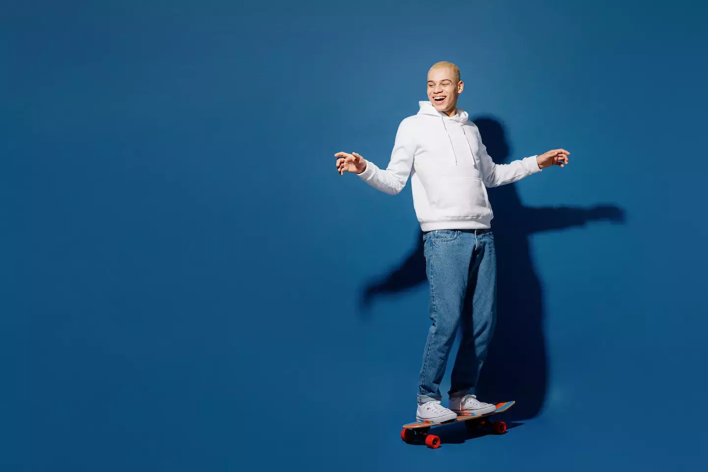 smiling man balancing on skateboard