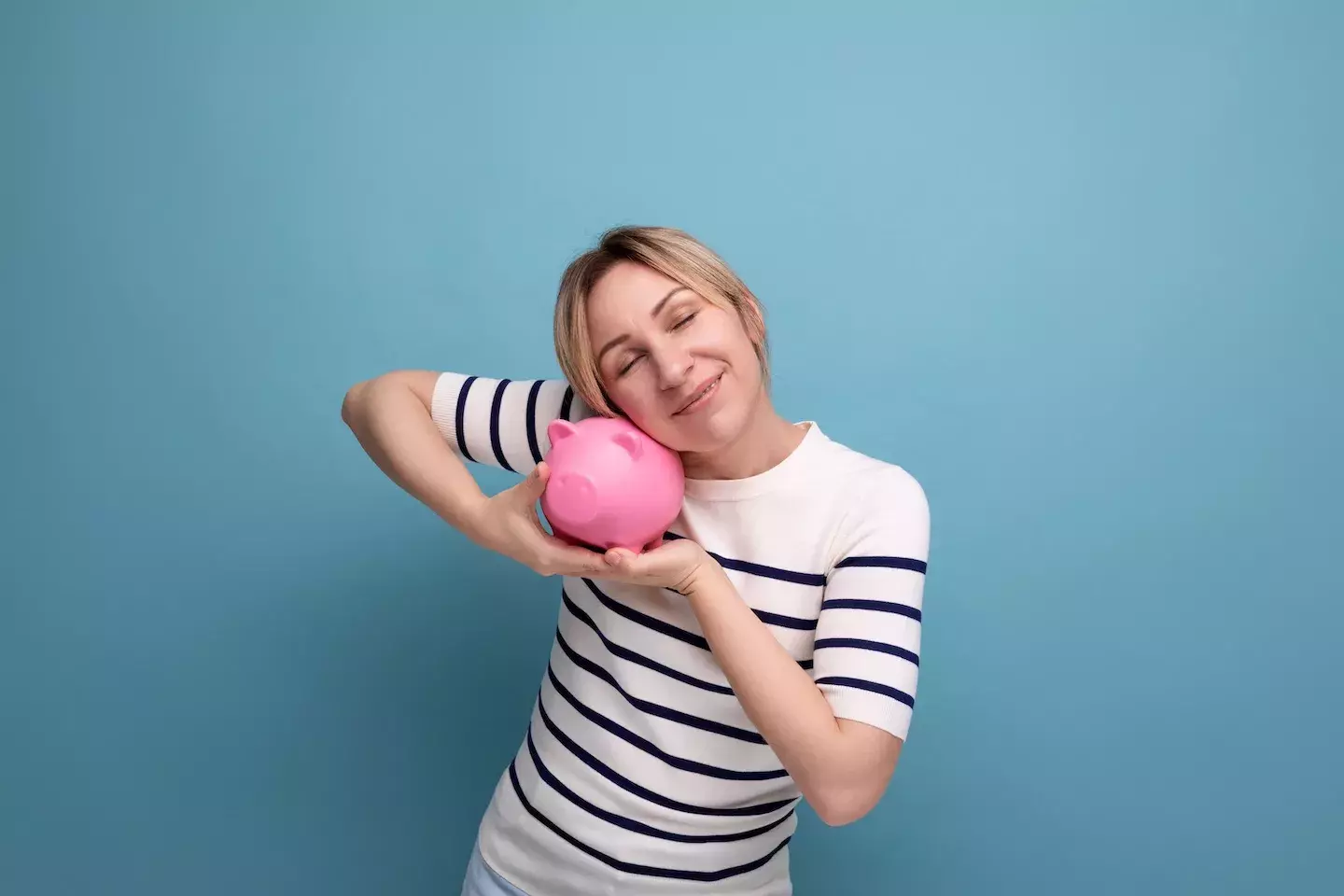 woman hugging piggy bank