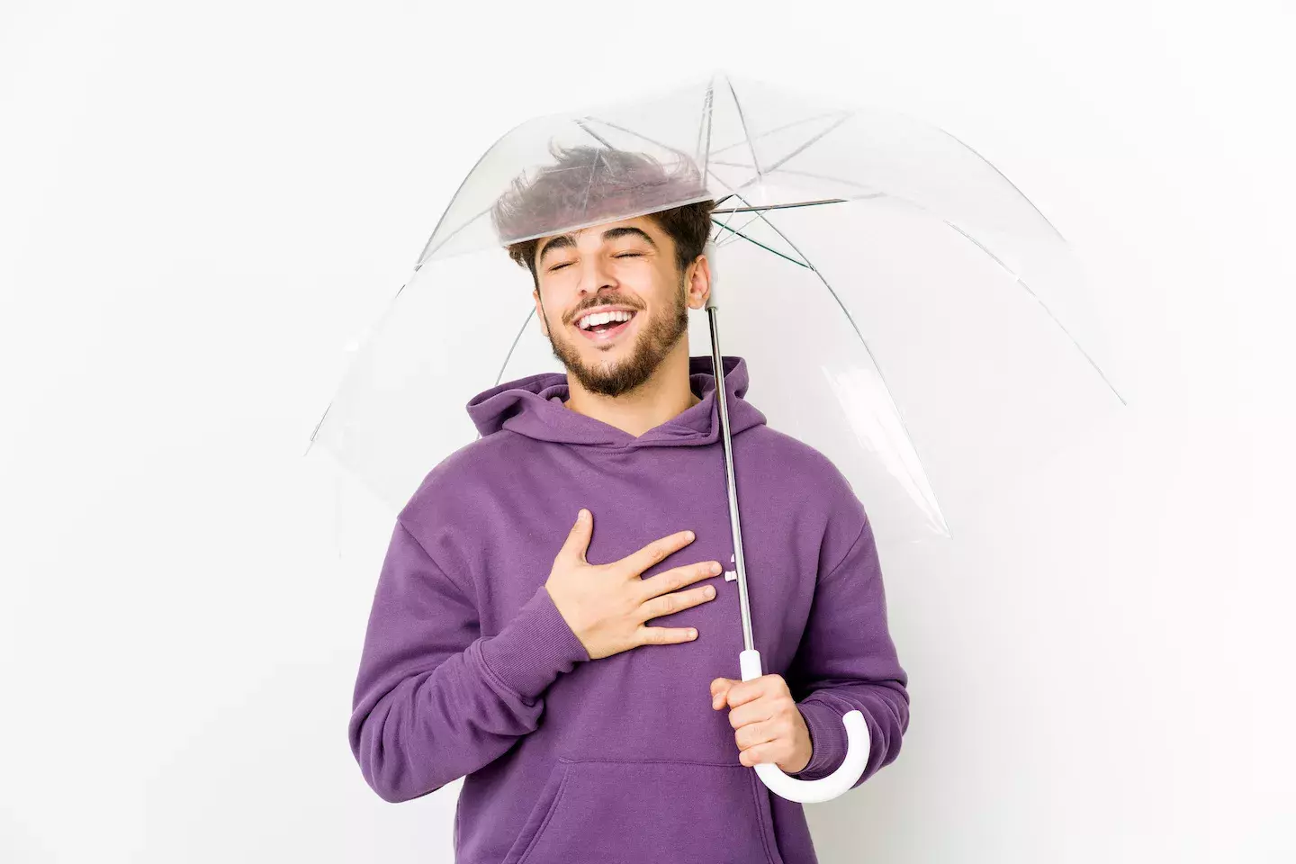 man holding umbrella with relieved expression