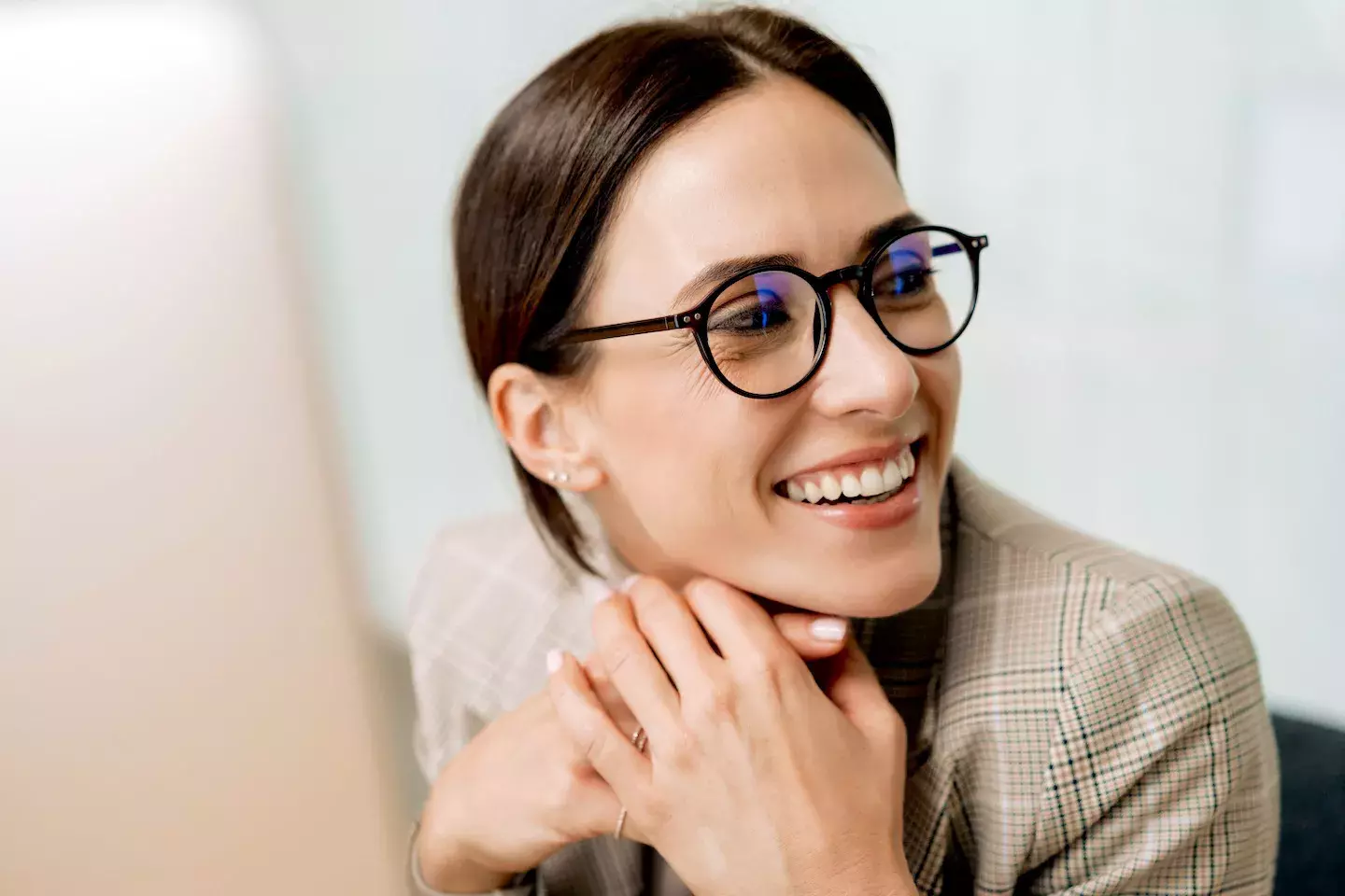 Woman at a computer smiling