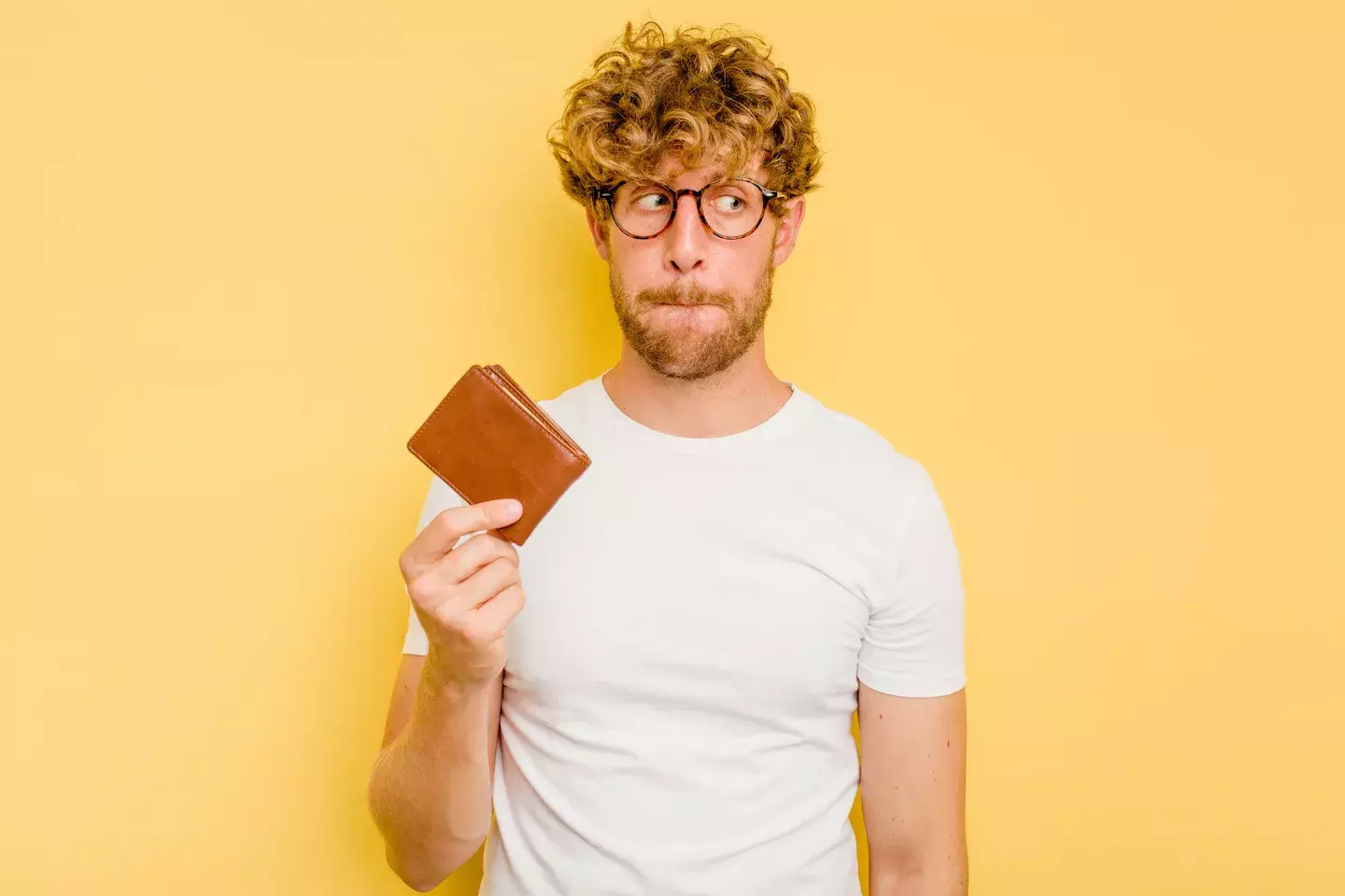 concerned man holding up wallet