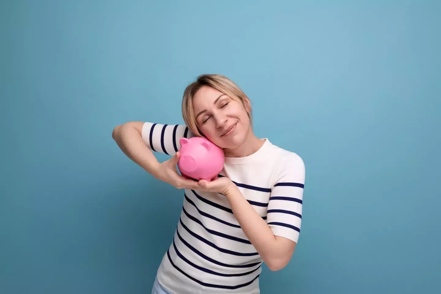 woman hugging piggy bank