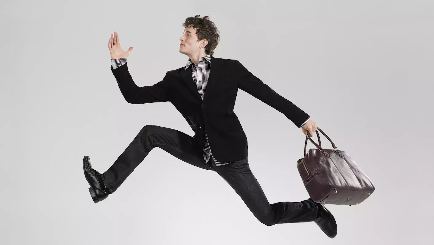 Business man leaping effortlessly 