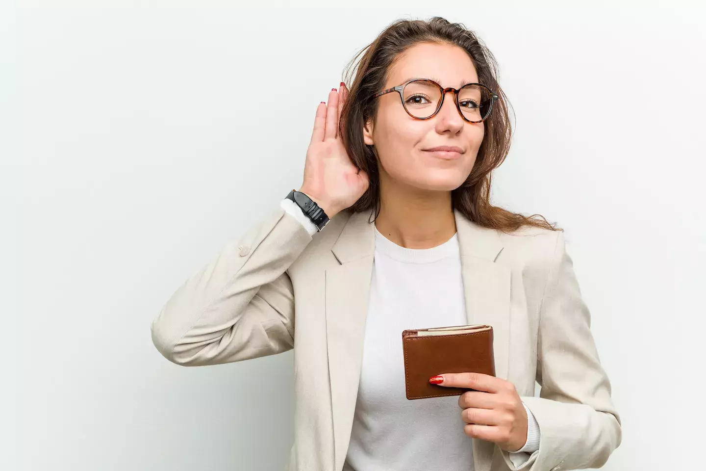 woman holding wallet holding hand up to ear to listen