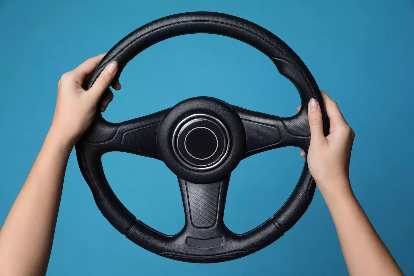 hands holding steering wheel