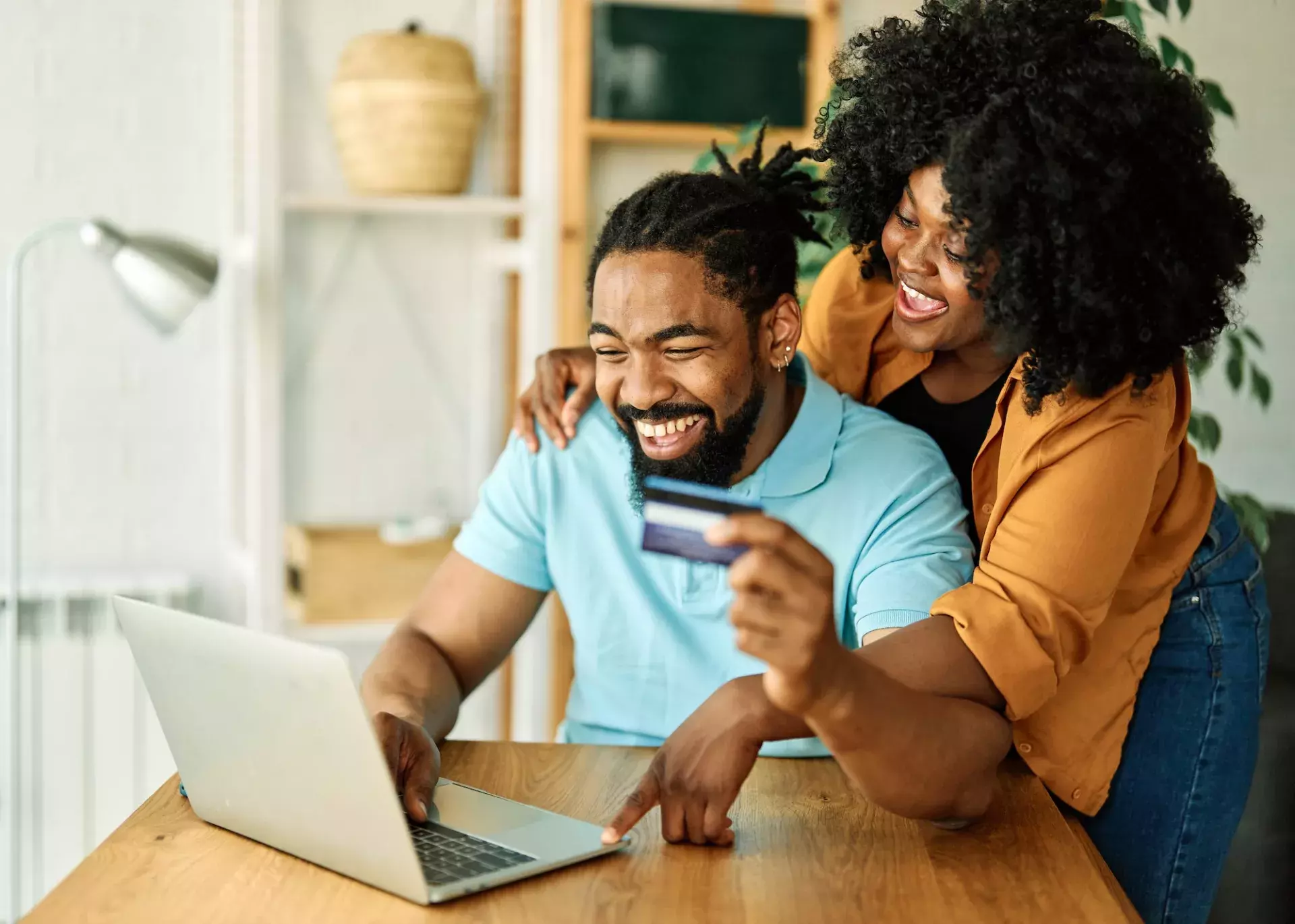 Couple on laptop with card