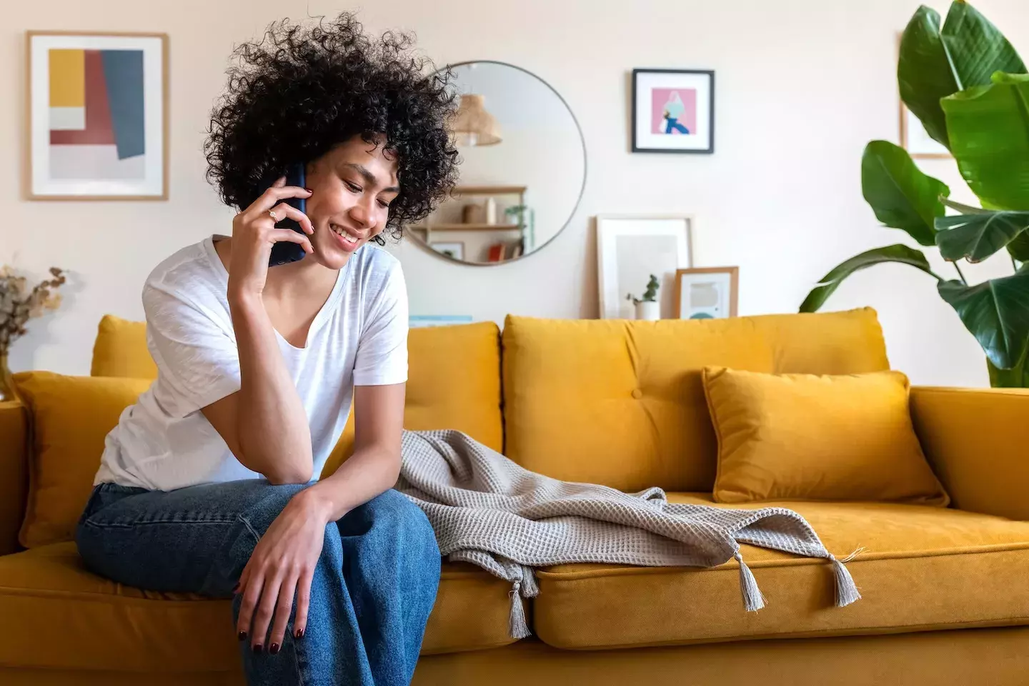 person sitting on couch and talking on phone