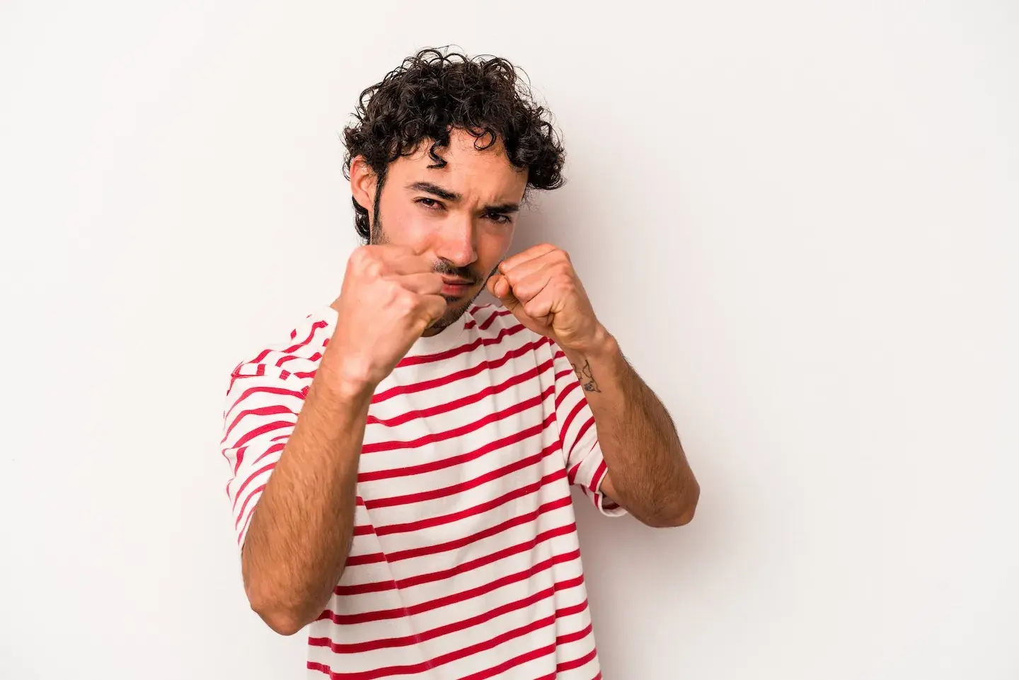 man holding up fists as to throw a punch