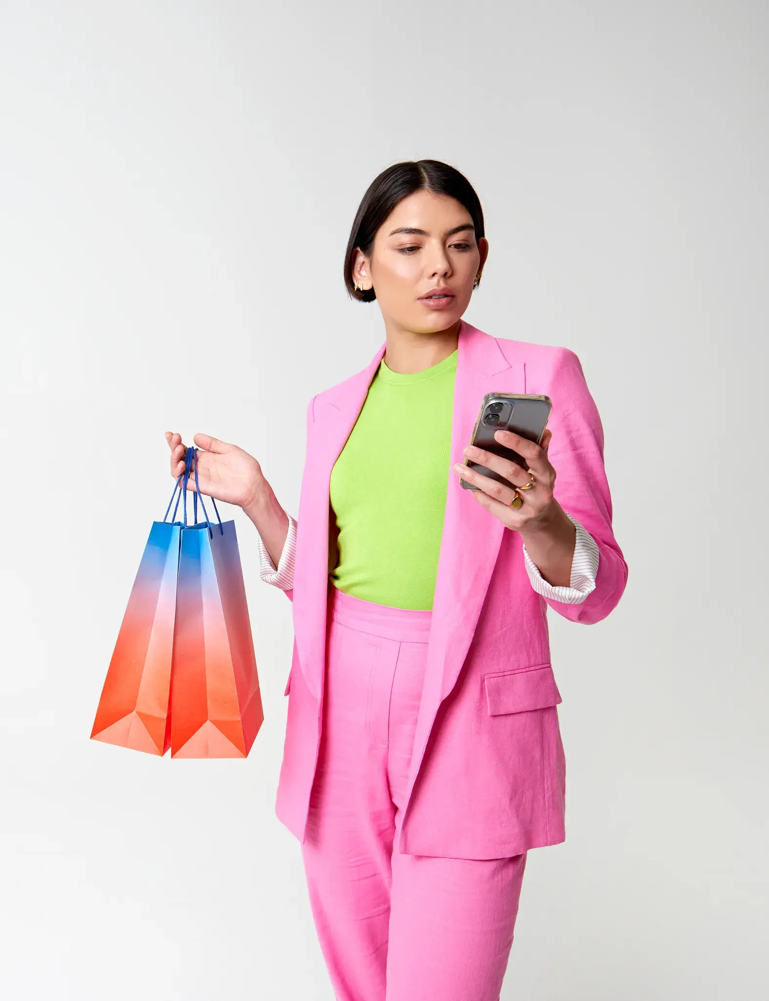 Woman with shopping bags looking at phone