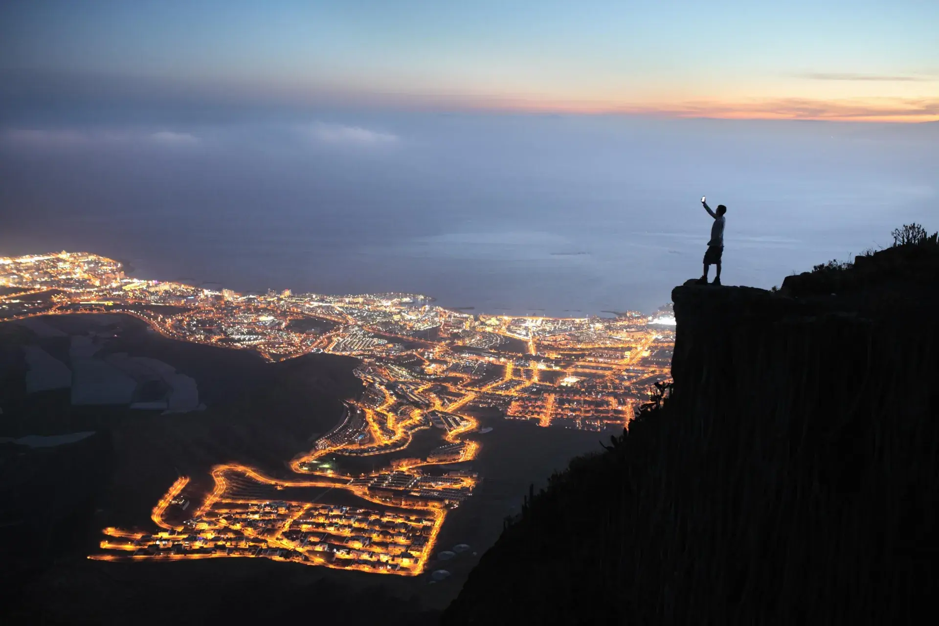 Person looking out into cityscape at night