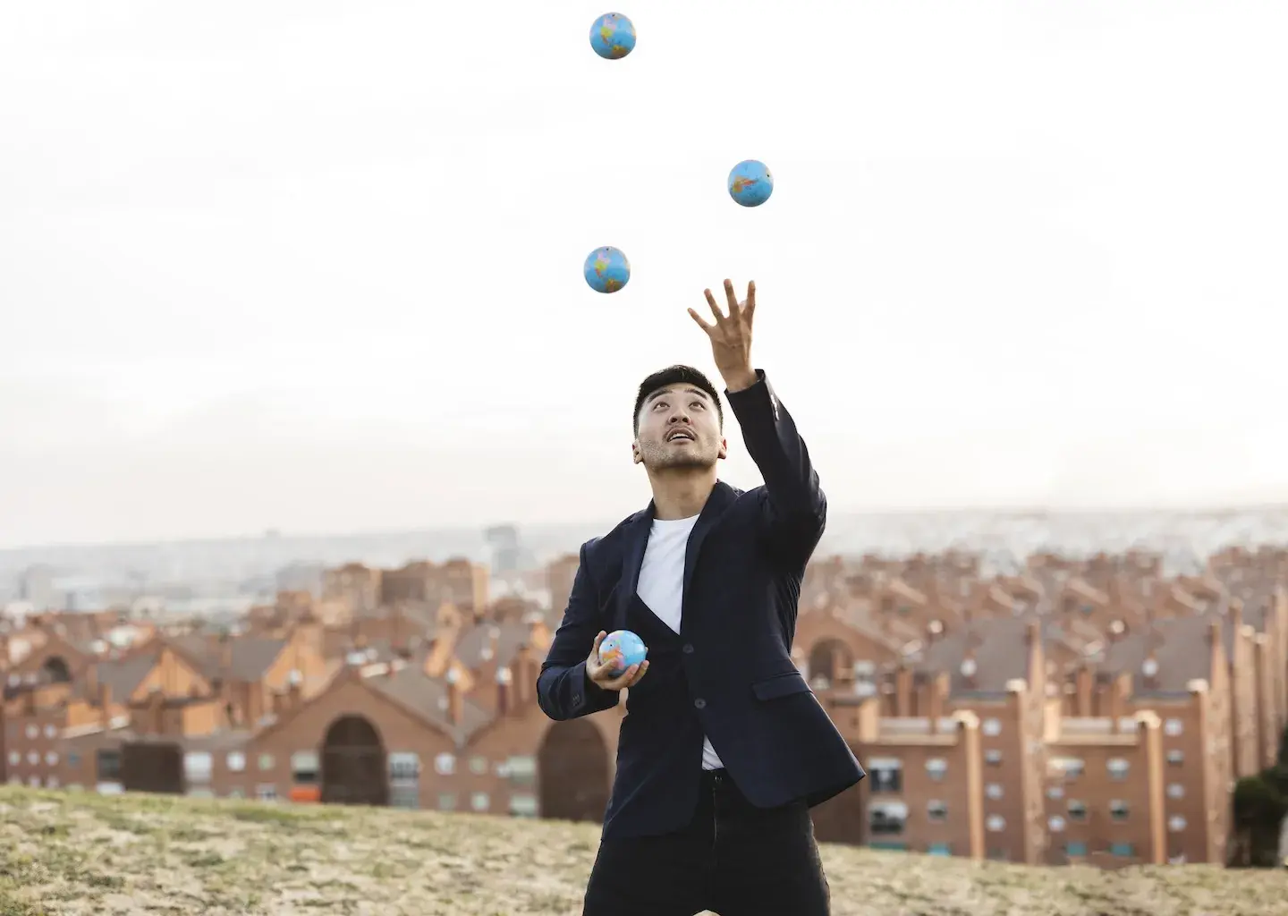 business man juggling little world balls