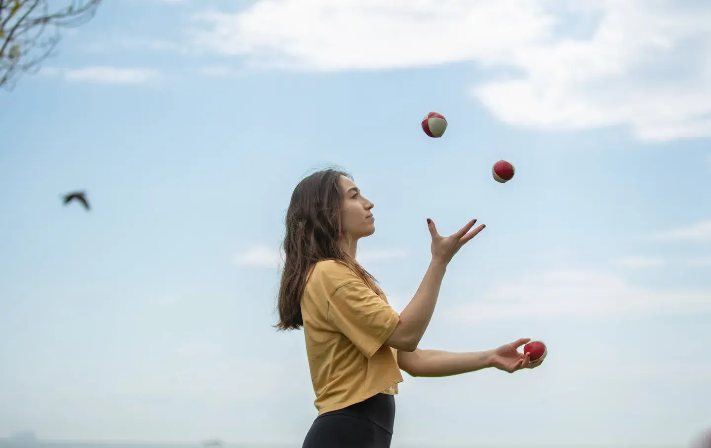 woman focused on juggling outdoors