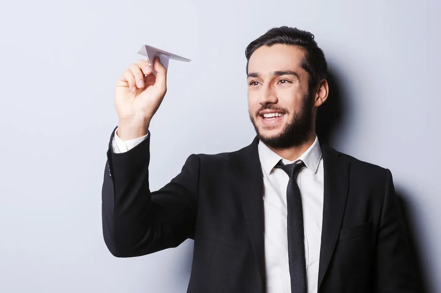 businessman throwing paper airplane 