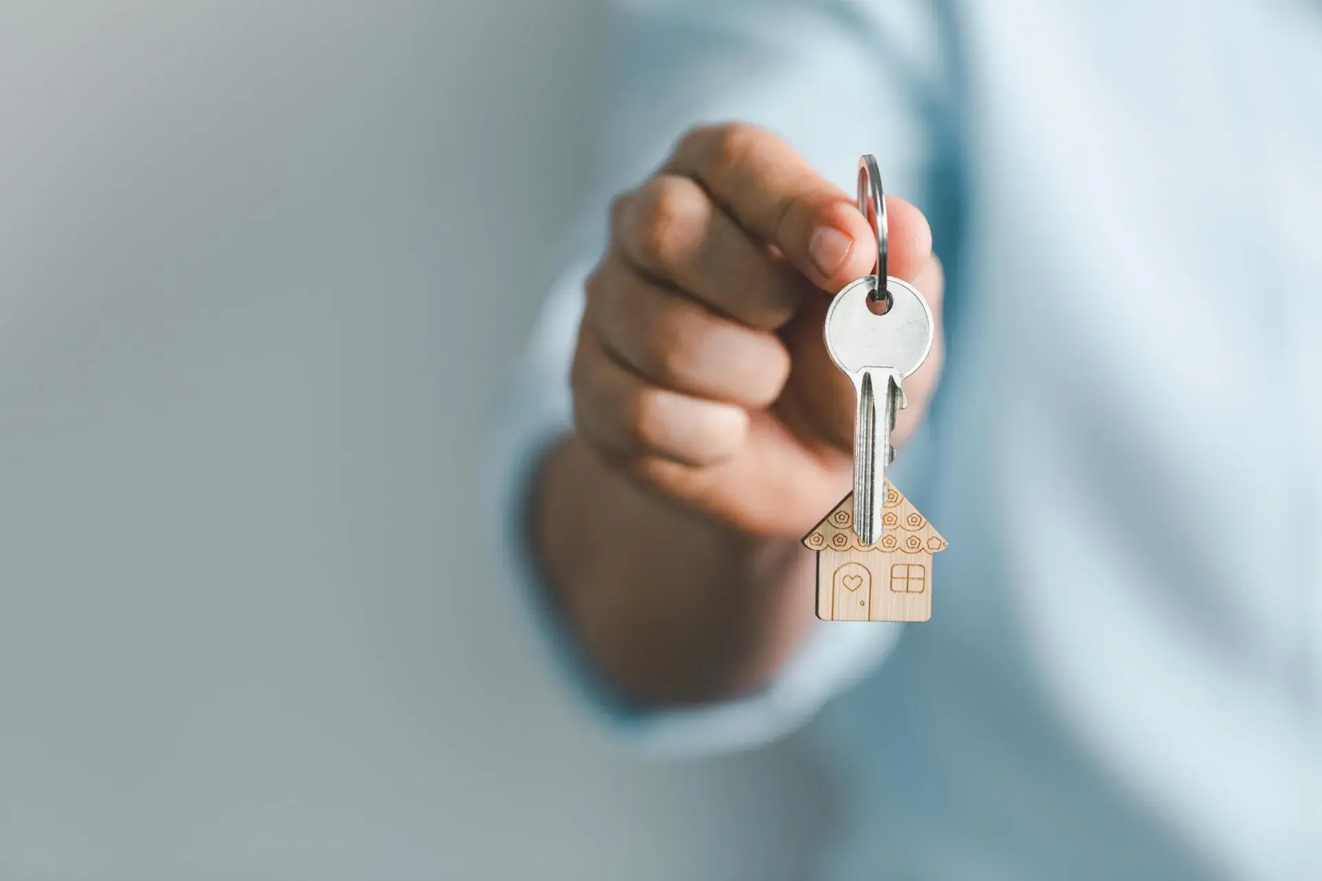hand extended holding a keychain of house keys