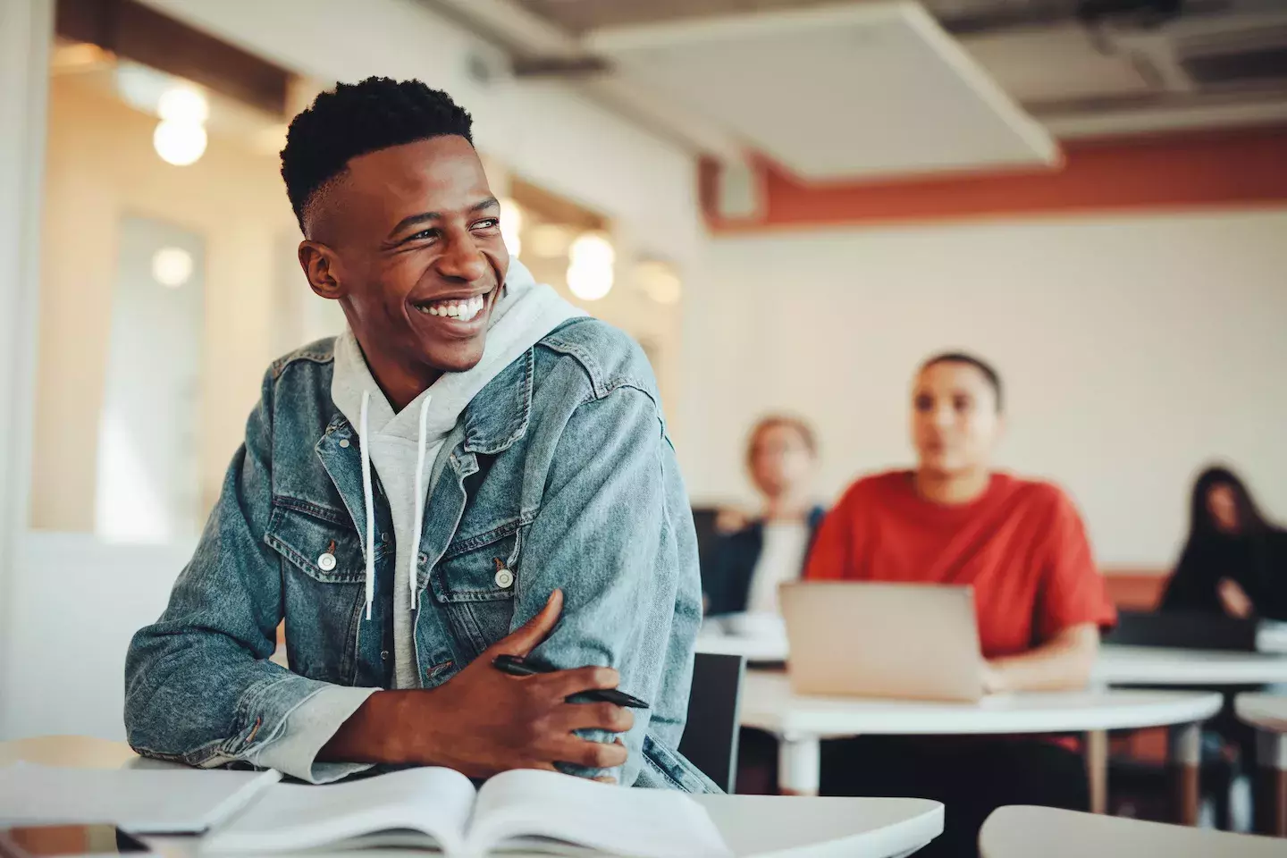 student smiling at desk